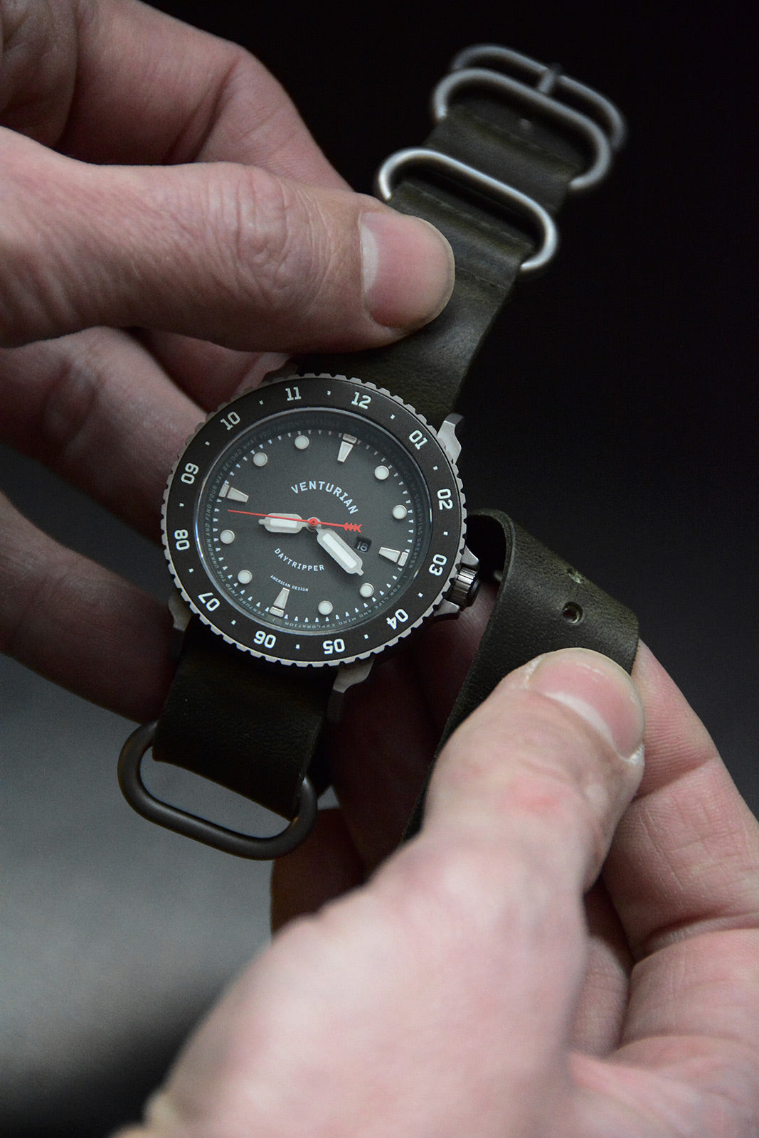 Venturian WatchWorks Daytripper mens watch — 38mm dual timer bezel -- black dial in hand.