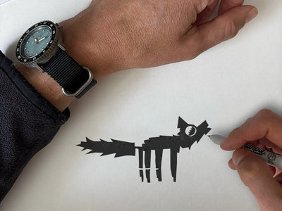 Venturian's founder jason strong draws a howlin' wolf folk art style in a sketchbook. 