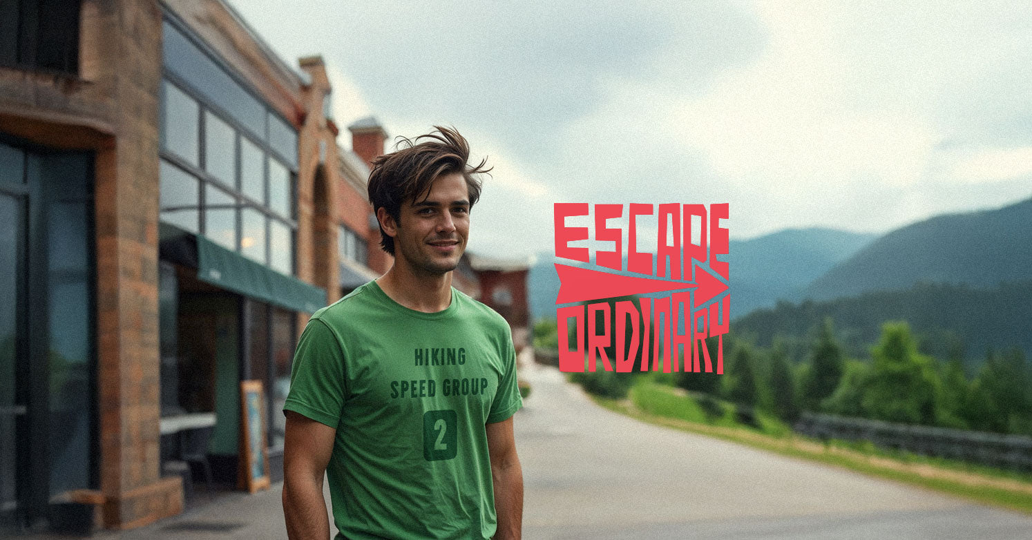 Man in a green t-shirt standing on a street with mountains in the background and 'Escape Ordinary' text.