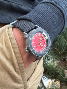 The Venturian Wildsider 38MM Solar Titanium compass tool watch in Red outdoors on wrist