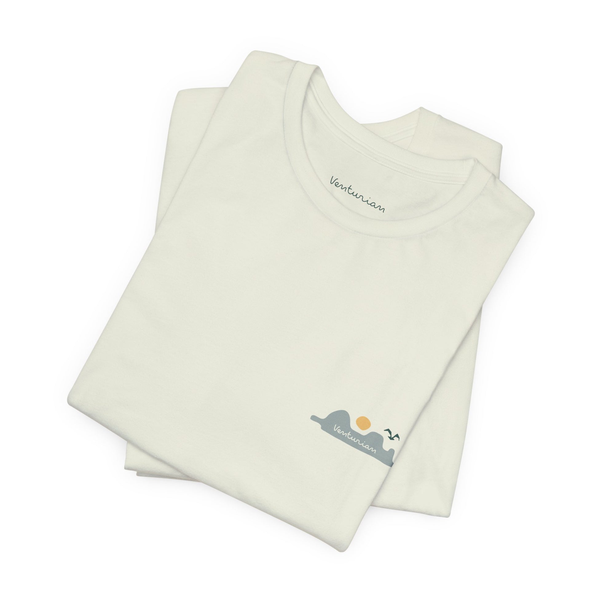 Folded cream-colored baby romper with a small graphic on a white background