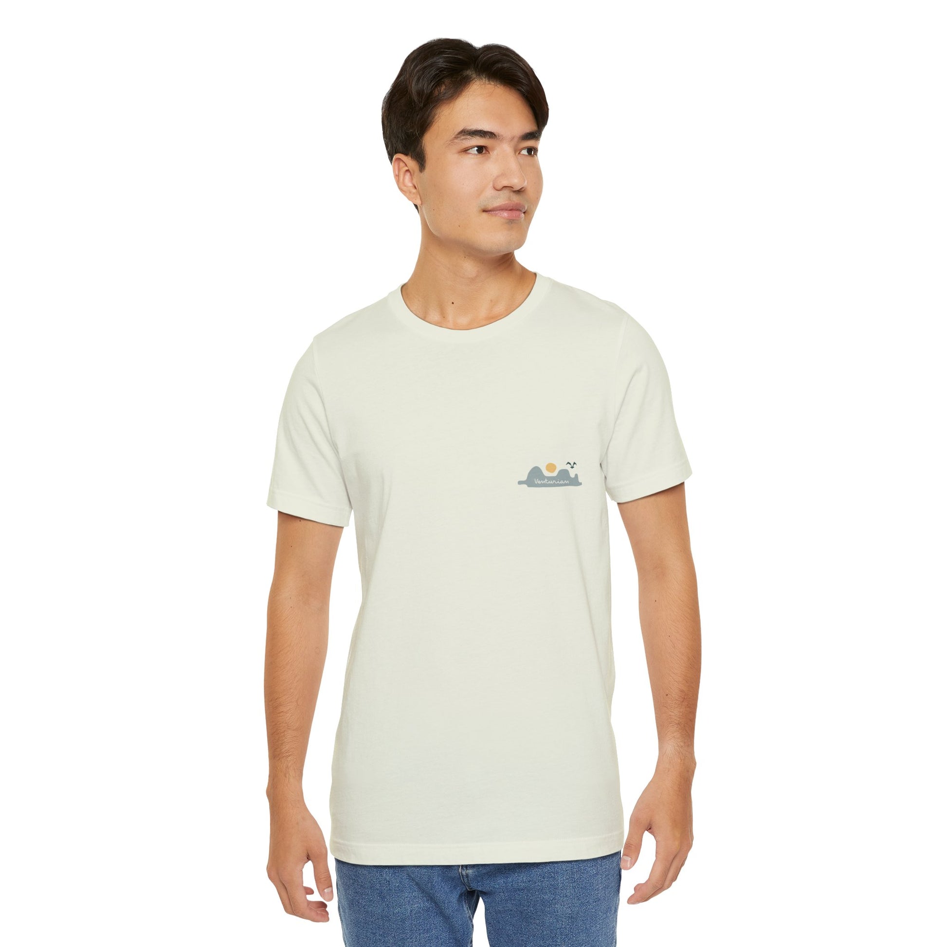 Man wearing a light-colored t-shirt with a small logo on a white background