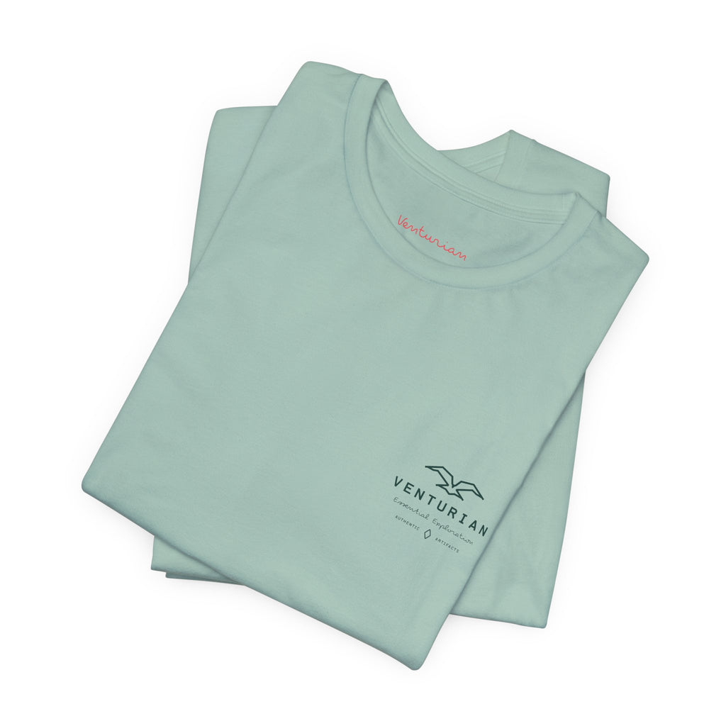 Folded dusty blue t-shirt with 'Venturian' branding on a white background
