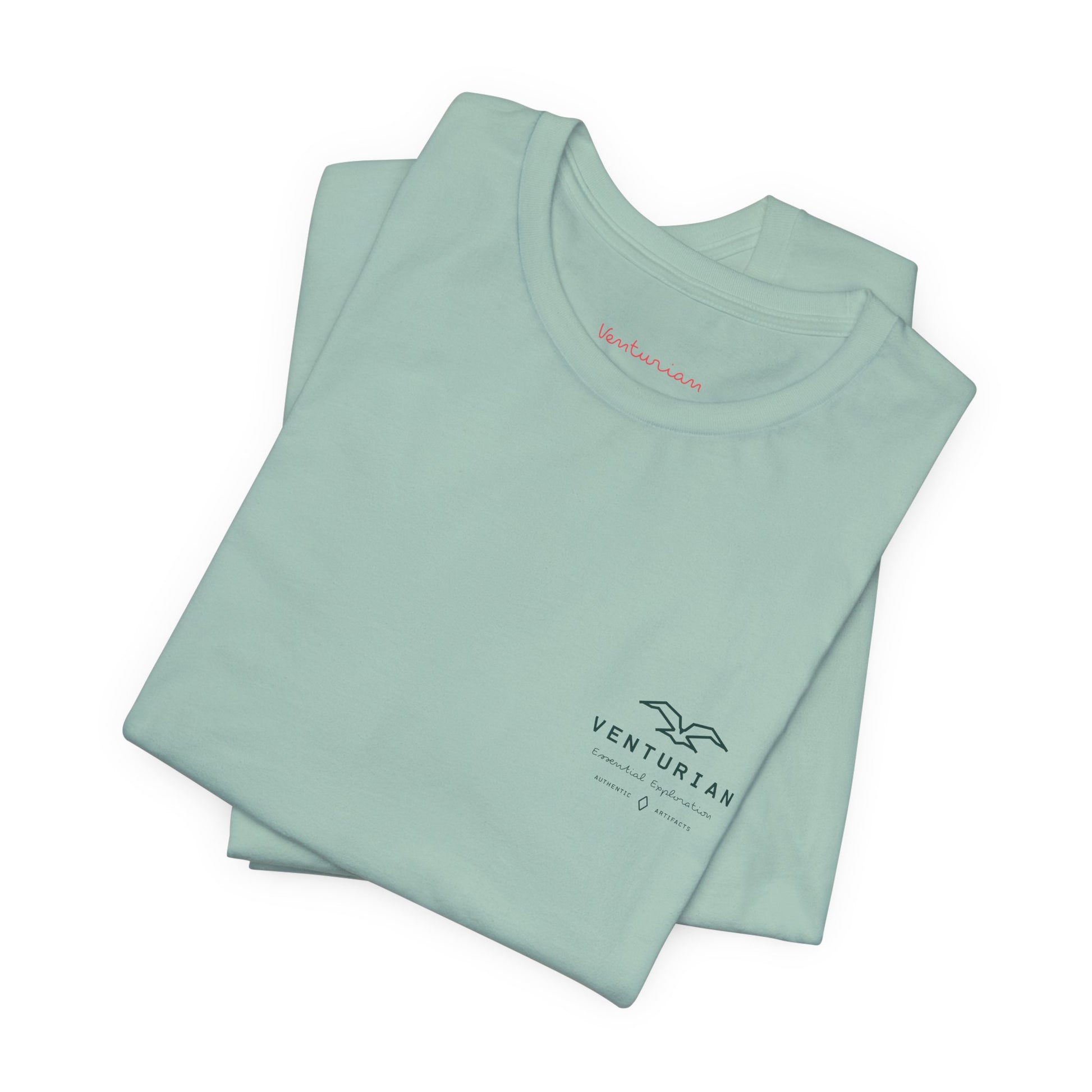 Folded dusty blue t-shirt with 'Venturian' branding on a white background