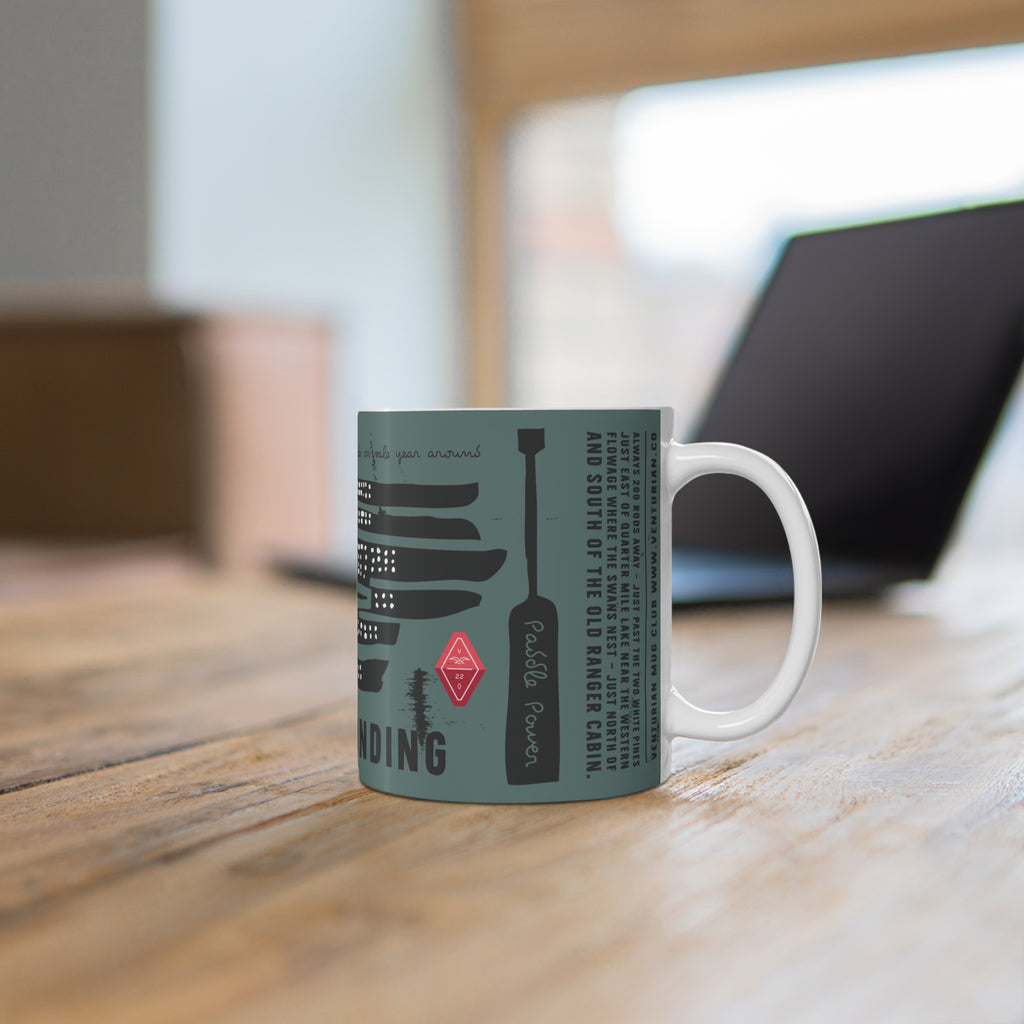 Mug with text and graphics on a wooden surface with a blurred background