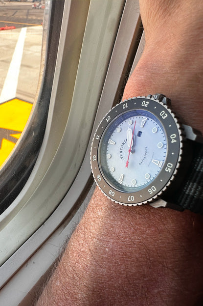 Close-up of a wrist wearing a watch with a blurred background