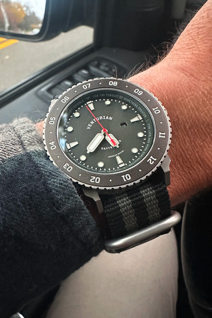 Person wearing a Victorinox watch inside a vehicle
